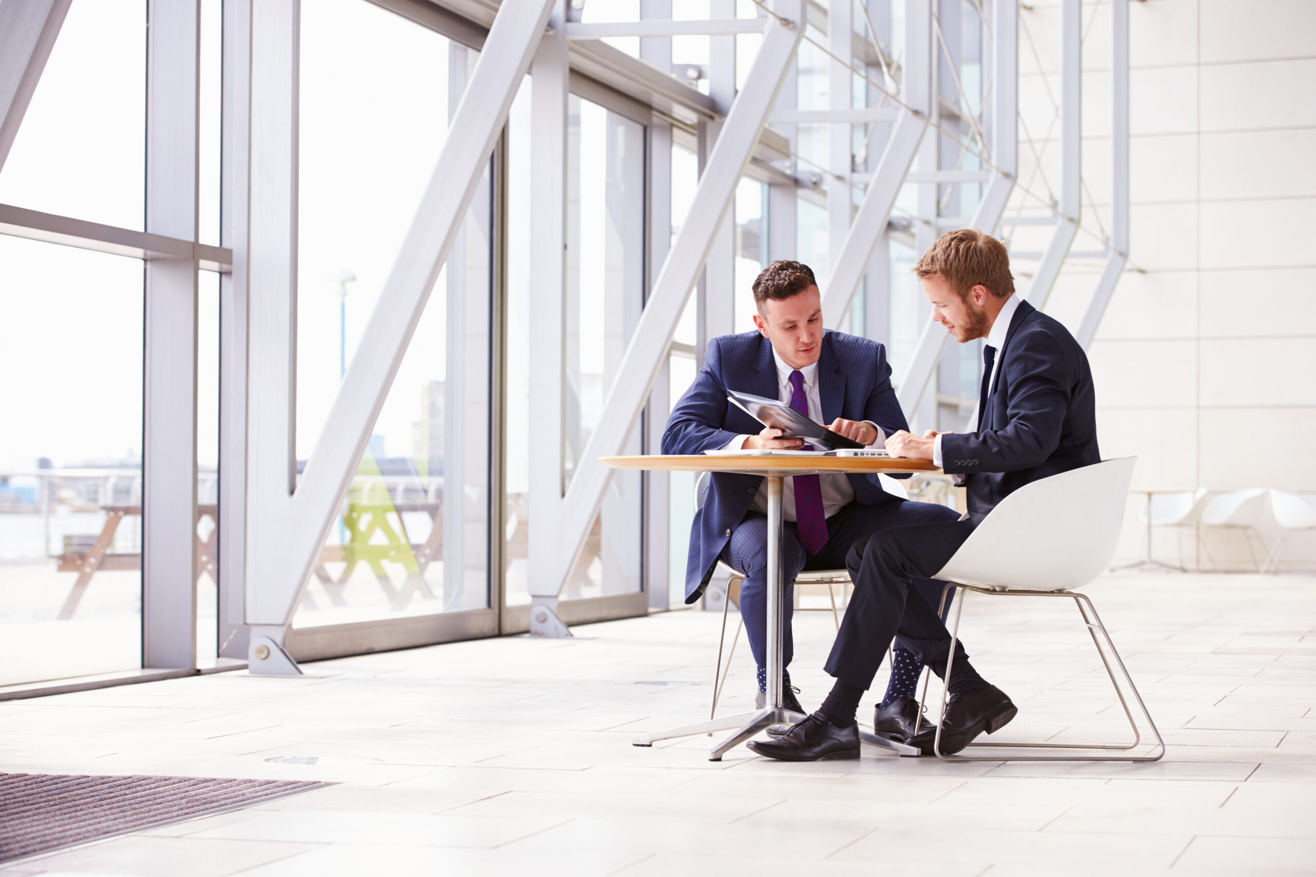 Two,Business,Colleagues,At,Meeting,In,Modern,Office,Interior